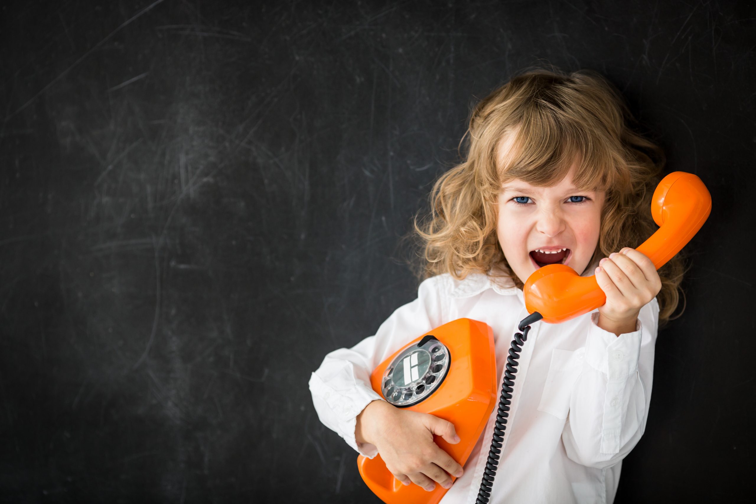 Aggressive kid calling by vintage phone