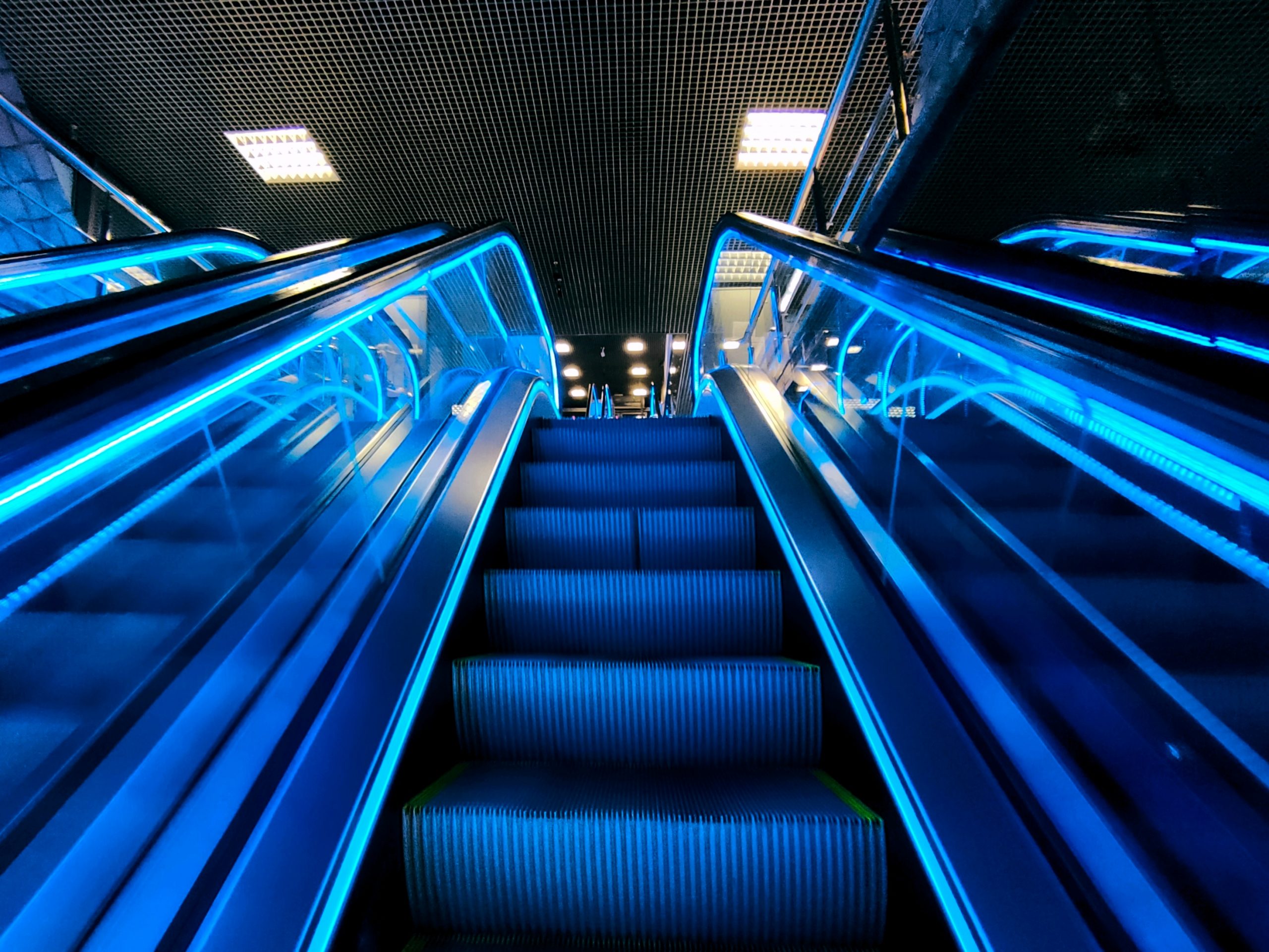 https://smpl.as/wp-content/uploads/2023/01/view-of-the-escalator-in-the-night-with-neon-blue-2022-11-01-04-45-34-utc-scaled.jpg
