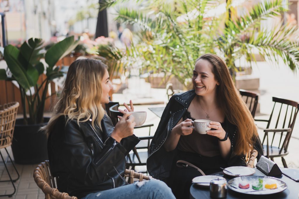 Two young women sitting in a street cafe