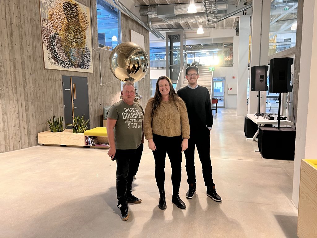 Compera CEO Lene with Smpl's Lasse and Andy, standing in the office hallway