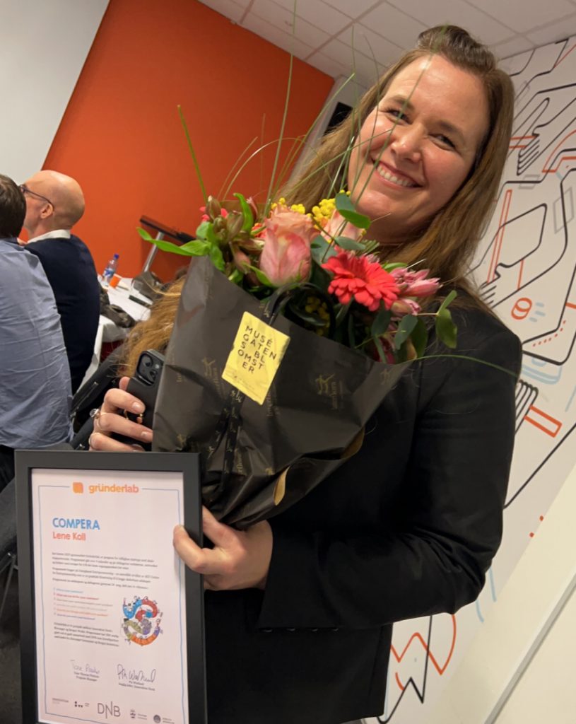 Lene, CEO of Compera, with her award and some flowers